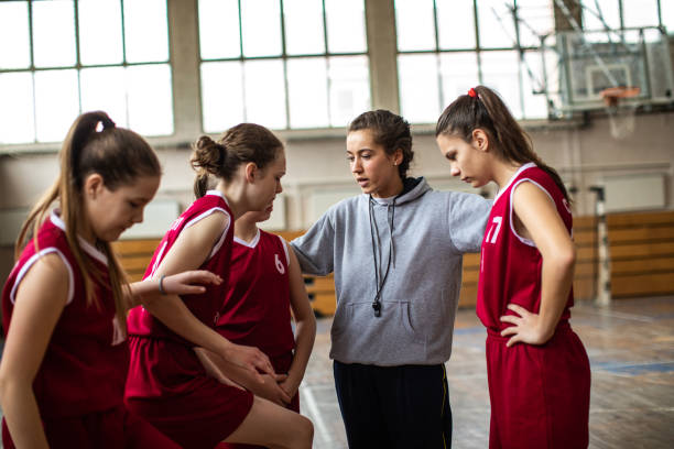 istock Beautiful basketball coach with her team 1132012536