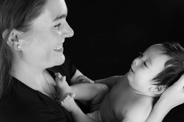 istock Side view of a smiling mother looking at her infant son 1132012696