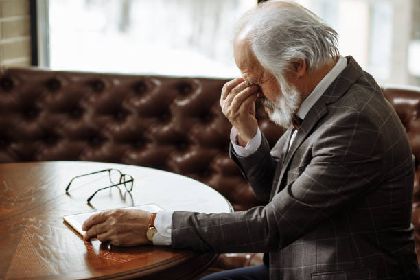 old businessman has problems with eyes. - human eye tired rubbing businessman imagens e fotografias de stock