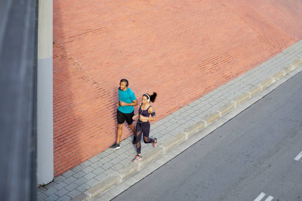 Small group of athletes in blurred motion running a marathon in nature.