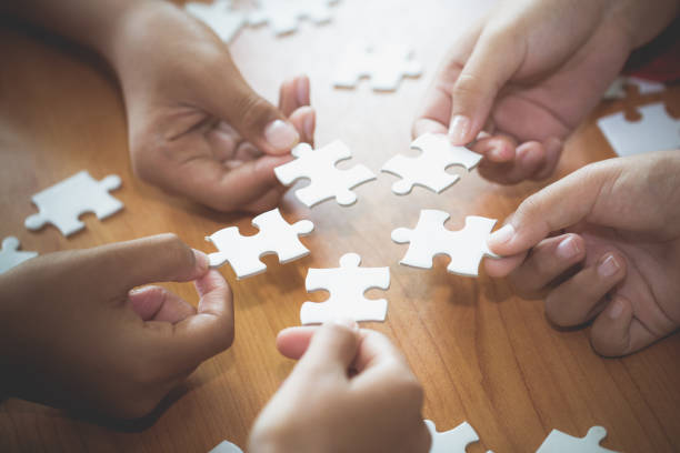 istock Business concept,  Group of business people assembling jigsaw puzzle and represent team support and help togethe 1132014177