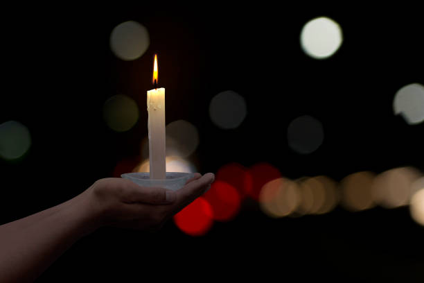 istock Holding a candle on blur background at the night 1132014795