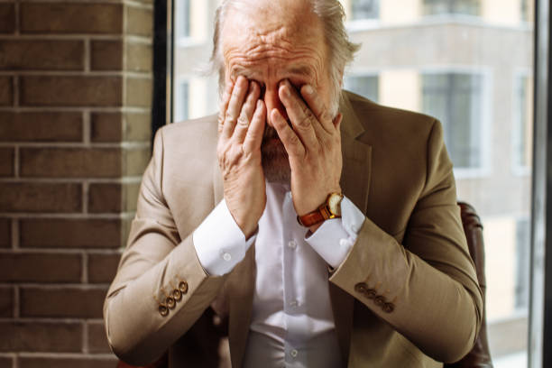 close up portrait of tired pensioner is closing face with hands - human eye tired rubbing businessman imagens e fotografias de stock