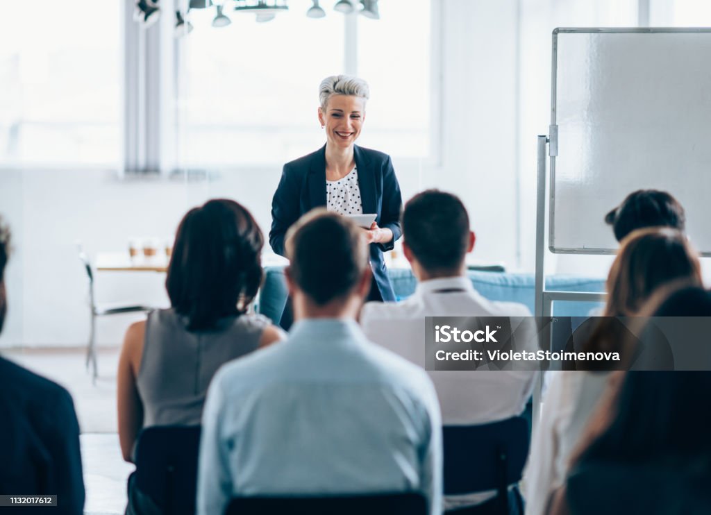 Business seminar Businesswoman leading a training class for professionals Education Training Class Stock Photo