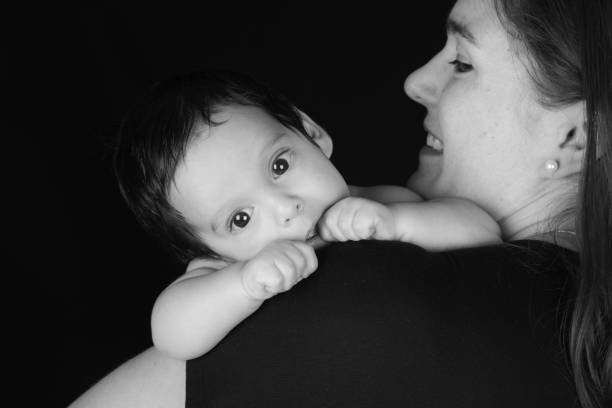 istock Mother holding her infant baby boy who is looking over her shoulder 1132017736