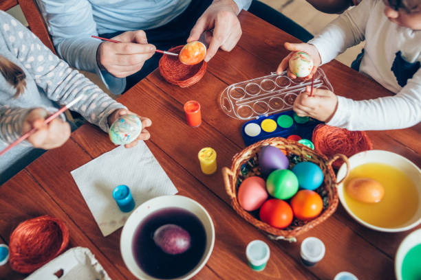 istock Happy family painting Easter eggs 1132018319