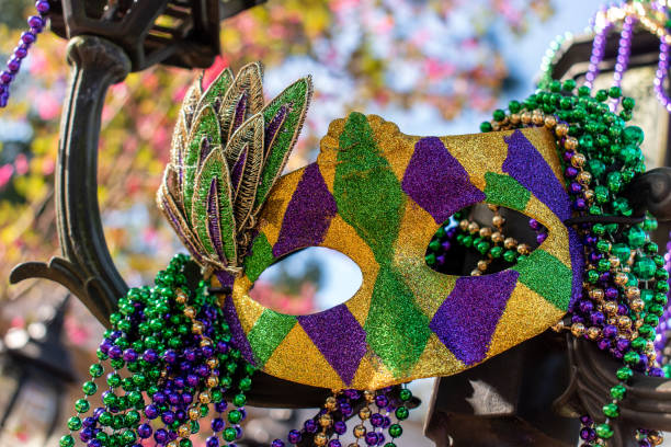 istock Outdoor Mardi Gras beads and mask on light post 1132019462