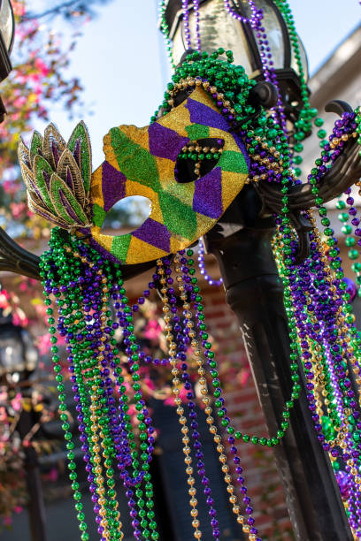 Outdoor Mardi Gras beads and mask on light post stock photo