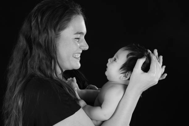 istock Side view of a smiling mother looking at her infant son 1132021593