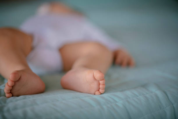 Baby leg fingers. Shadow DOF. Developed from RAW; retouched with special care and attention; Small amount of grain added for best final impression. 16 bit Adobe RGB color profile.