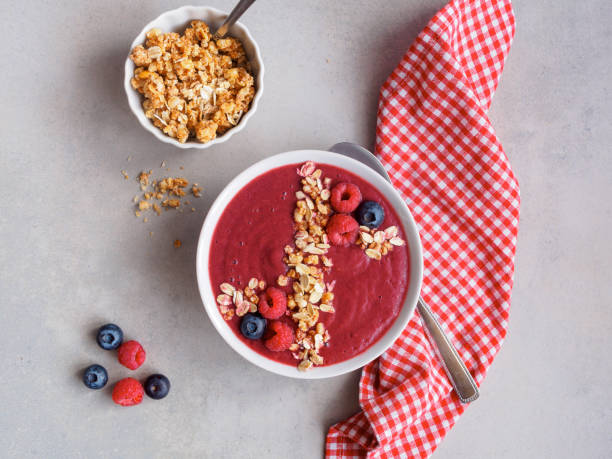 Red berries smoothie with cereal fruit, food, breakfast, top view, spoon, napkin, checkered, oatmeal, amerikanische heidelbeere stock pictures, royalty-free photos & images