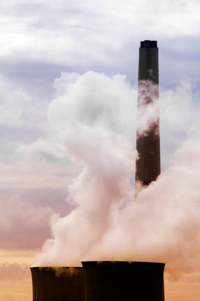 istock Power plant at dusk, chimneys, smoke, pollution. 1132028110