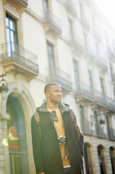 istock Young man standing with hands in pockets in city 1132030476