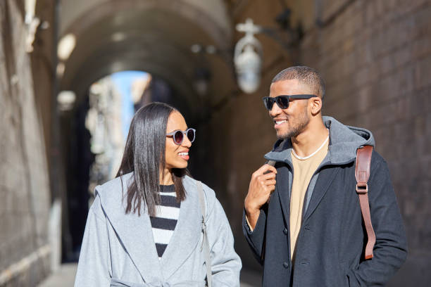 istock Smiling couple standing in alley on sunny day 1132030491