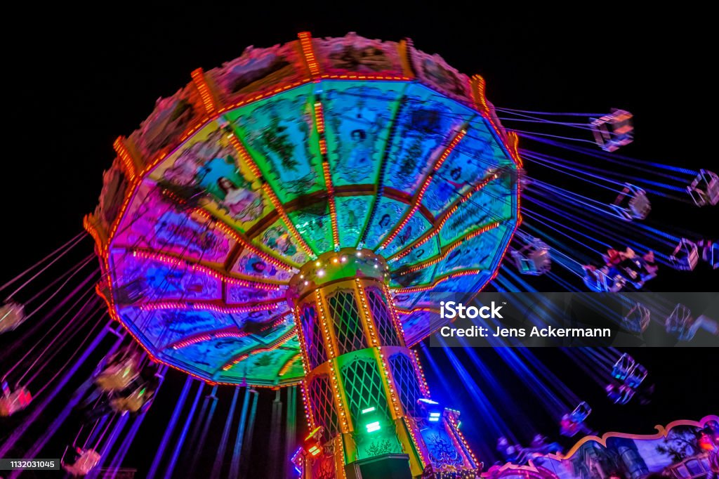 Chain carousel at night Traveling Carnival Stock Photo