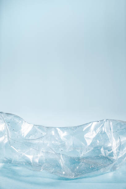 istock Plastic waste concept: discarded crumpled water bottle in blue background. 1132037292