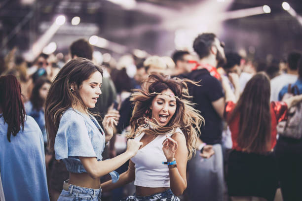 istock Happy women having fun while dancing on a music festival. 1132037370
