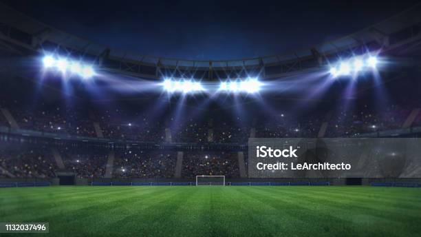 Grand Football Stadium Illuminated By Spotlights And Empty Green Grass Playground Stock Photo - Download Image Now
