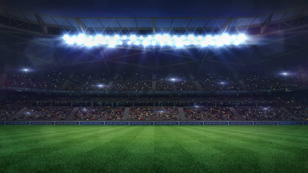 gran estadio de fútbol vista media iluminada por focos y césped verde vacío - playing field flash fotografías e imágenes de stock