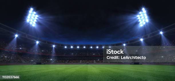 Universal Grass Field Stadium Illuminated By Spotlights And Empty Green Grass Playground Stock Photo - Download Image Now