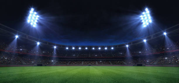 universal grass field stadium illuminated by spotlights and empty green grass playground - quiet time imagens e fotografias de stock