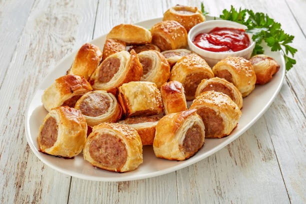 istock freshly baked Puff pastry Sausage rolls, close-up 1132040913