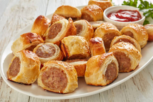istock freshly baked Puff pastry Sausage rolls, close-up 1132040932