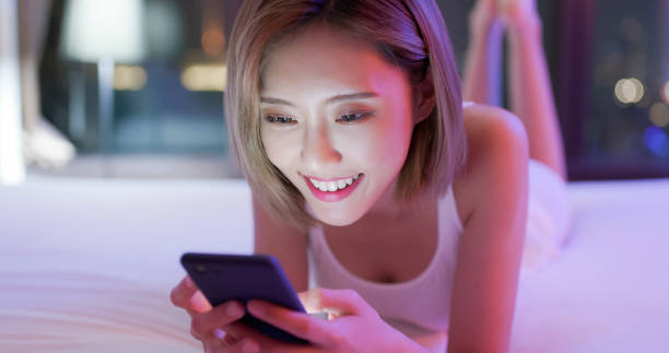 istock woman use phone on bed 1132040997