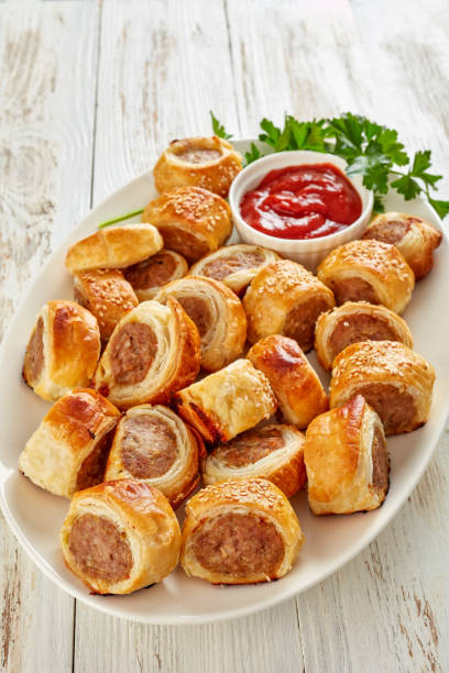 istock freshly baked Puff pastry Sausage rolls, close-up 1132041021