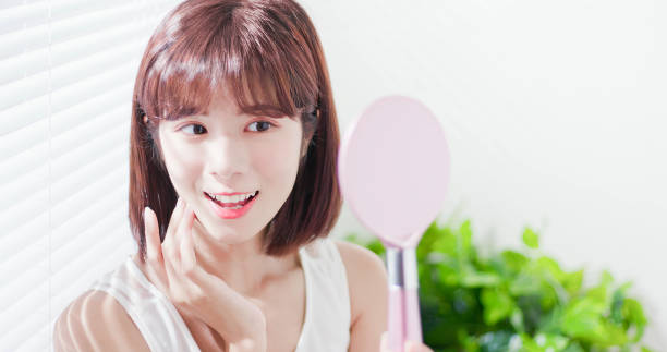 istock Young asian woman look mirror 1132041082