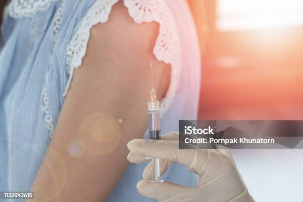 World Immunization Week And International Hpv Awareness Day Concept Woman Having Vaccination For Influenza Or Flu Shot Or Hpv Prevention With Syringe By Nurse Or Medical Officer Stock Photo - Download Image Now