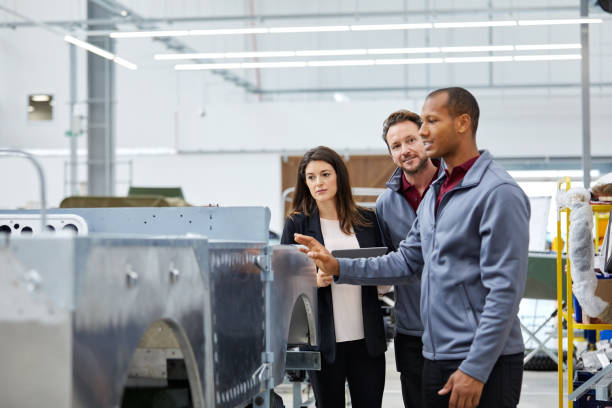 istock Engineer showing incomplete car to colleagues 1132045045