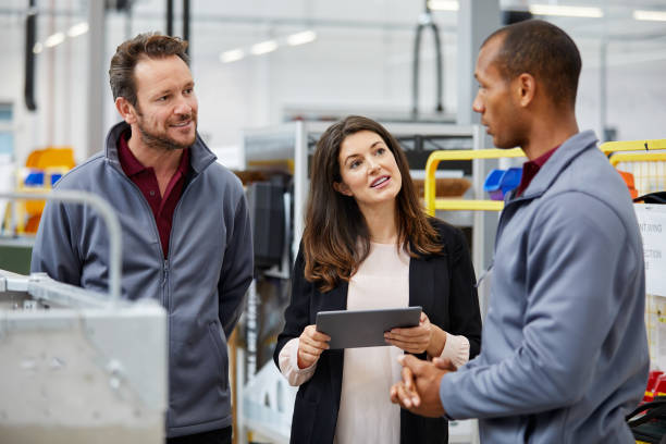 istock Manager discussing with engineers in car factory 1132045051