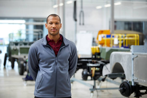 istock Male engineer standing in automobile industry 1132045065