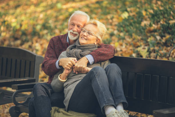istock Happy autumn senior couple on park bench 1132045672