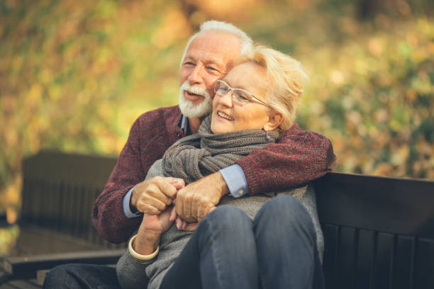 istock Happy autumn senior couple on park bench 1132045677