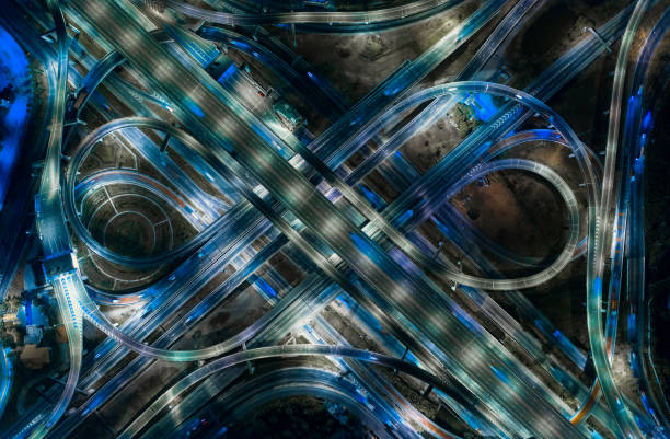 istock Aerial View of Busy Highway Road Junctions at Night from a drone. The Intersecting Freeway Road Overpass The Eastern Outer Ring Road. 1132046325