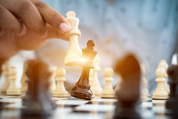istock playing wooden chess pieces, business concept 1132047699