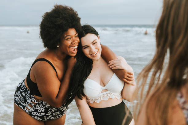 istock Cheerful beautiful plus size women at the beach 1132048028