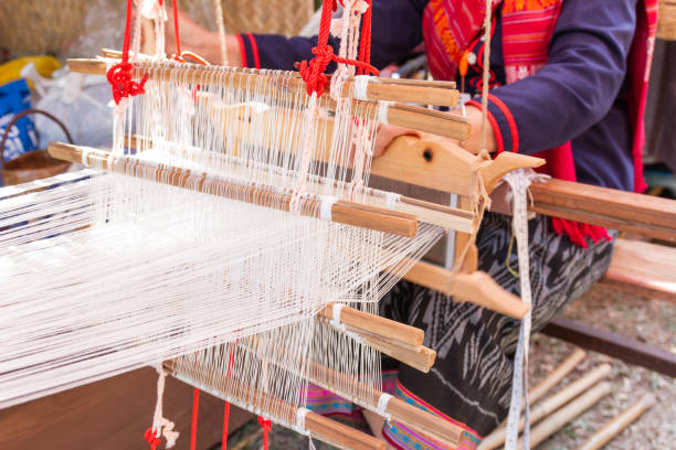 istock Old women are using the machine - Household Loom weaving 1132051164