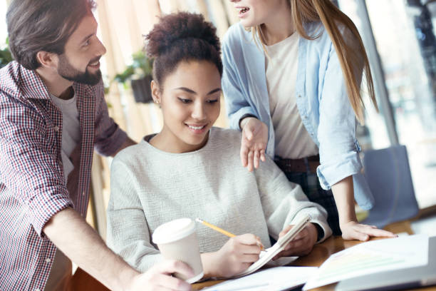 istock Young people coworking together at creative office sitting takin 1132053621