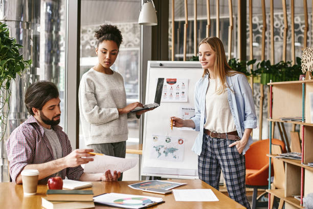 istock No one can whistle a symphony. It takes a whole orchestra to play it. Three co-workers are comparing results and developing a strategy 1132053770