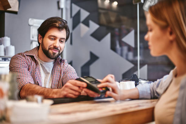 istock There is nothing shameful about being efficient. Small business, payment, people and service concept - woman with credit card buying coffee at cafe or coffee shop 1132053892
