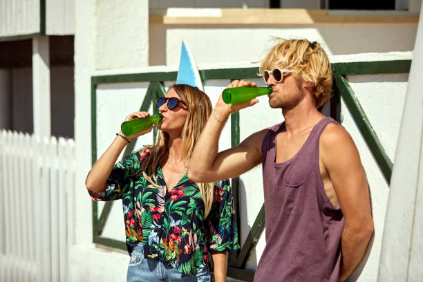 Couple drinking beer together at beach