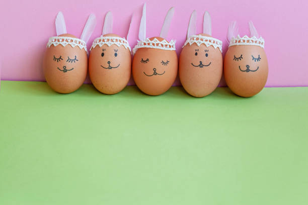 istock Funny easter bunnies eggs on green and pink paper background with copy space. Happy Easter concept. 1132055045