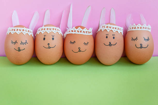 istock Funny easter bunnies eggs on green paper background with copy space. Happy Easter concept 1132055056
