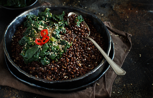 Black beluga lentils and spinach stew close up