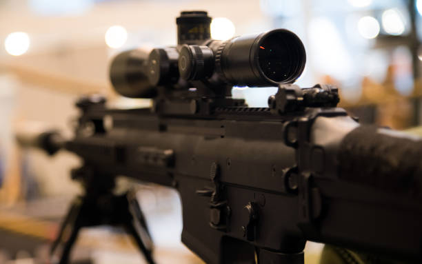 istock Young soldier aiming machine gun at target during military training in cadet corps. Cadet corps - initial military training school with the full Board to prepare youth for a military career. 1132055779