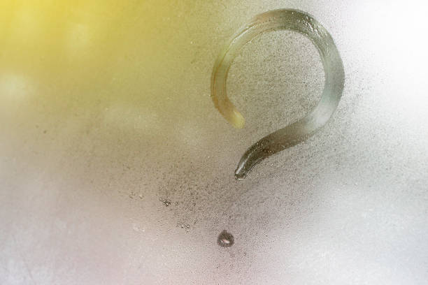 istock question mark on the window glass background, toned 1132056190