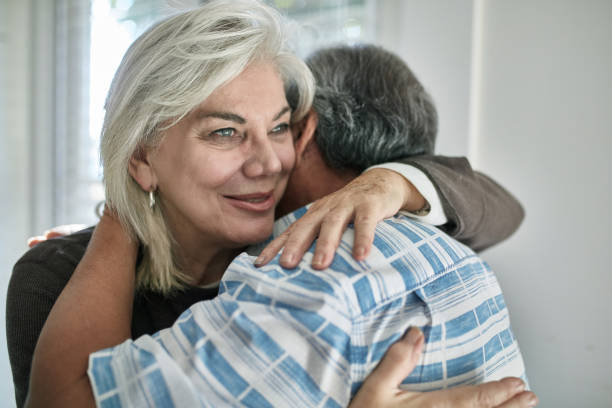 istock Elderly couple embracing at home 1132057847